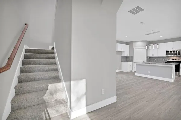 a view of kitchen with wooden floor and electronic appliances