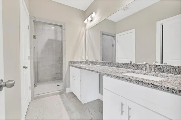 a bathroom with a granite countertop sink mirror and double