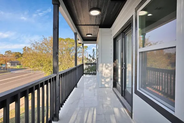 a view of a balcony with wooden floor