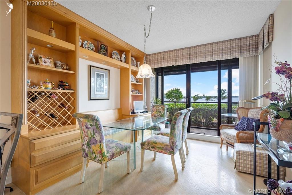2824 Southeast Dune Drive, Unit 2102 Jensen Beach, FL 34957 - Photo 14 of 40 a view of a dining room with furniture window and outside view