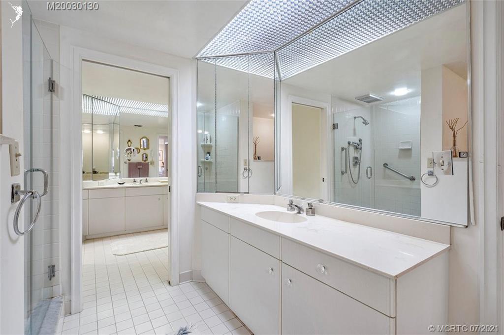 2824 Southeast Dune Drive, Unit 2102 Jensen Beach, FL 34957 - Photo 24 of 40 a bathroom with a sink a toilet and shower