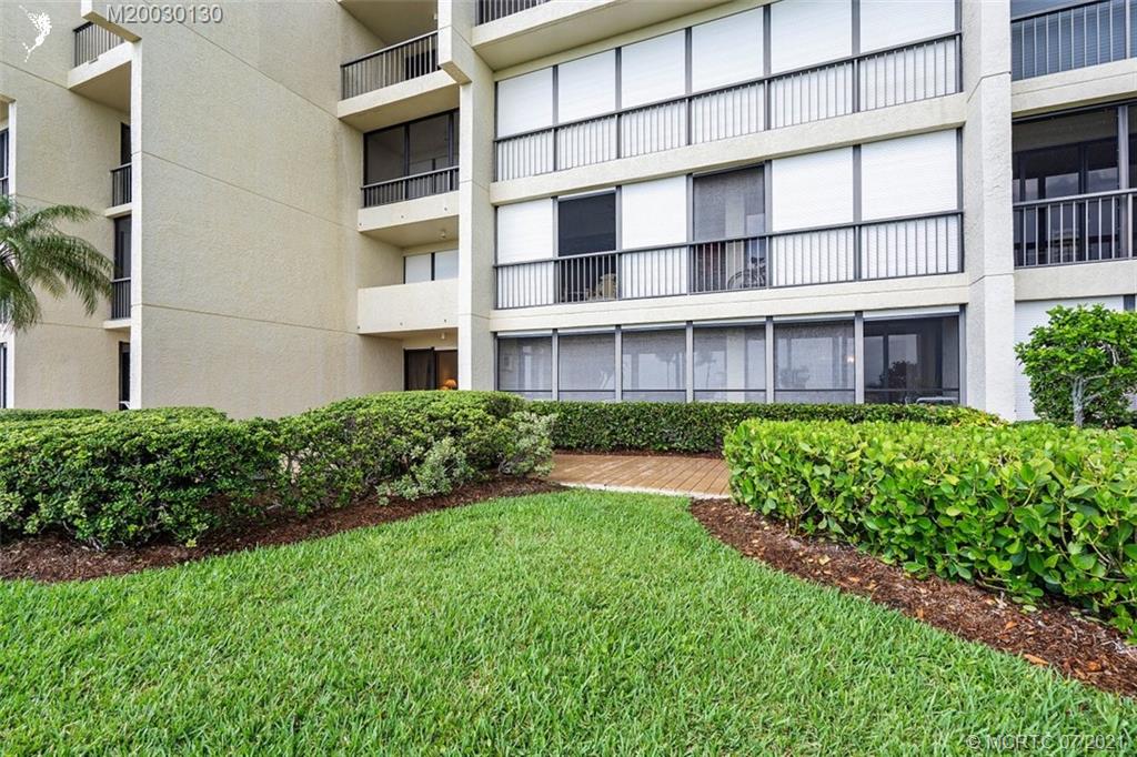 2824 Southeast Dune Drive, Unit 2102 Jensen Beach, FL 34957 - Photo 29 of 40 front view of a building with a yard