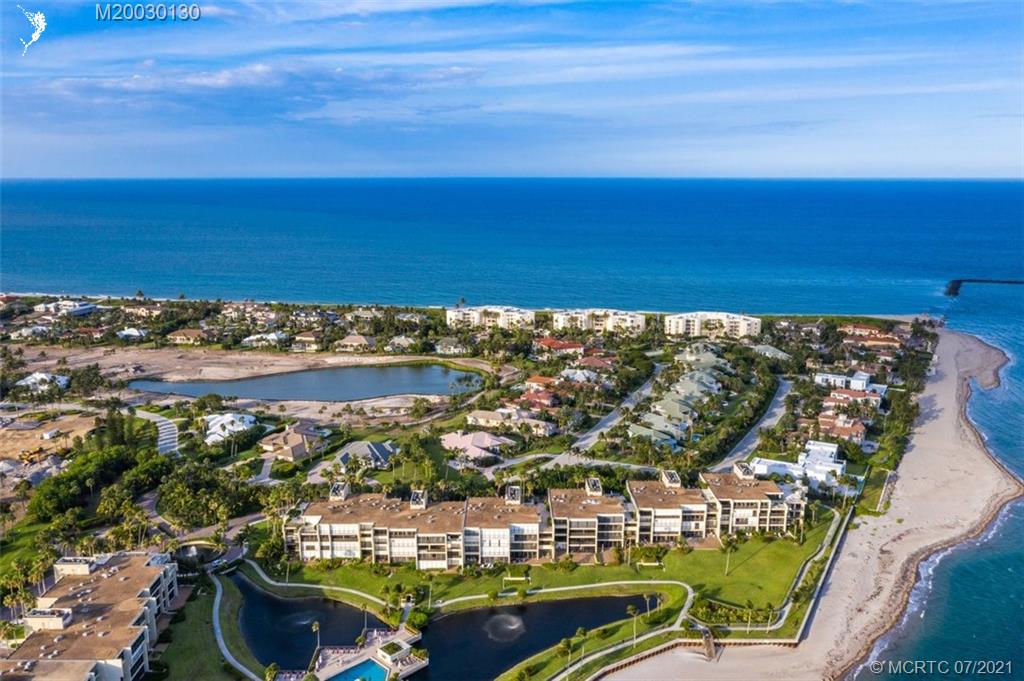 2824 Southeast Dune Drive, Unit 2102 Jensen Beach, FL 34957 - Photo 33 of 40 a view of a lake with a table and chairs