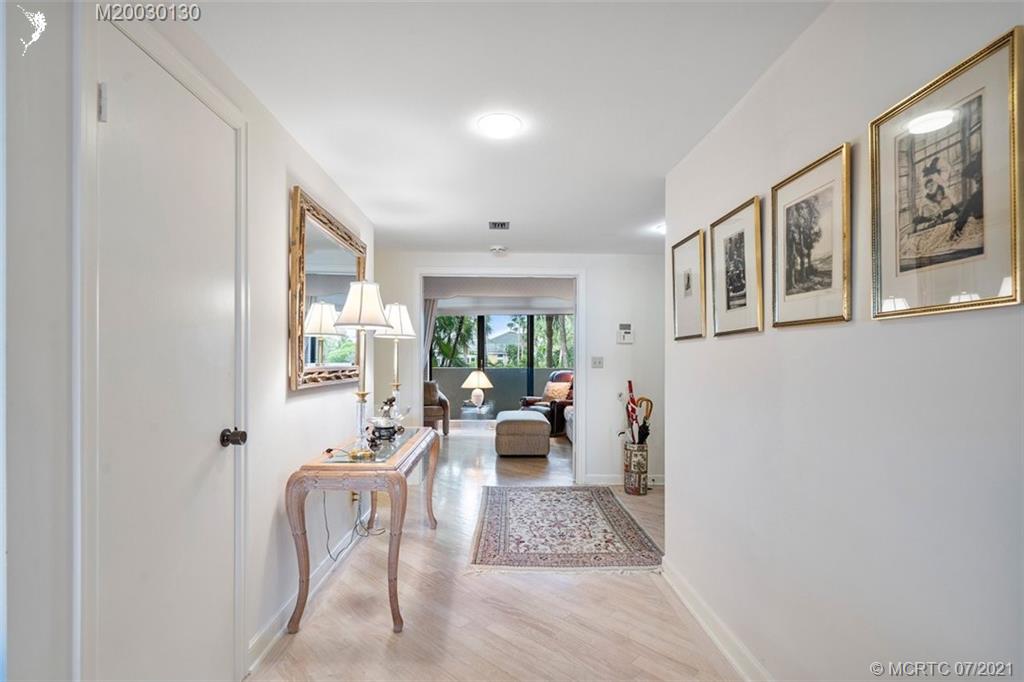 2824 Southeast Dune Drive, Unit 2102 Jensen Beach, FL 34957 - Photo 4 of 40 a living room with furniture and a large window