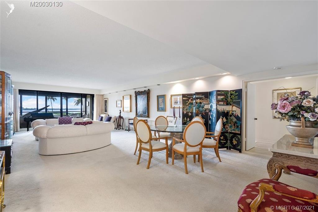 2824 Southeast Dune Drive, Unit 2102 Jensen Beach, FL 34957 - Photo 5 of 40 a living room with furniture and a large window