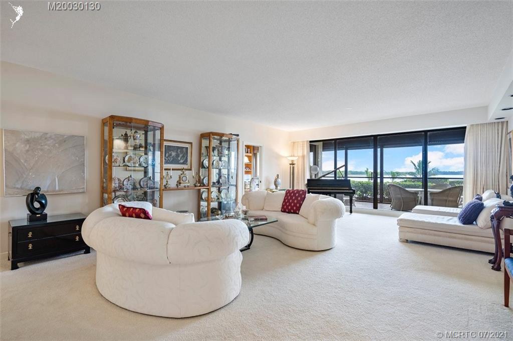 2824 Southeast Dune Drive, Unit 2102 Jensen Beach, FL 34957 - Photo 6 of 40 a living room with furniture and a large window