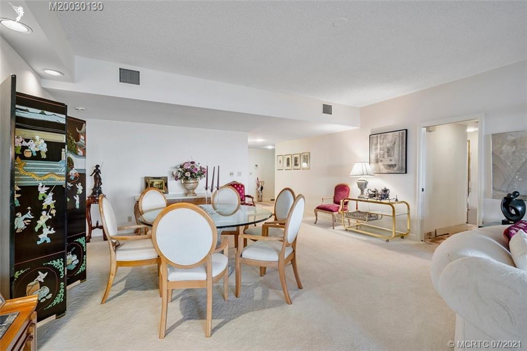 2824 Southeast Dune Drive, Unit 2102 Jensen Beach, FL 34957 - Photo 9 of 40 a view of a dining room with furniture and a kitchen