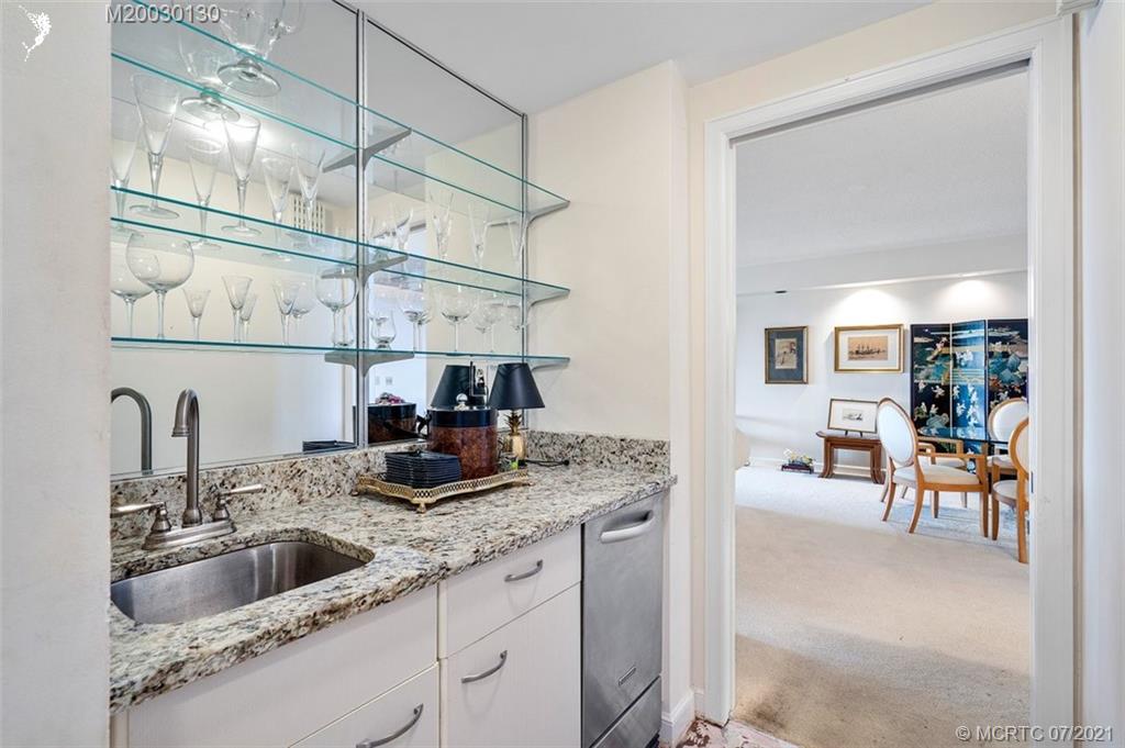 2824 Southeast Dune Drive, Unit 2102 Jensen Beach, FL 34957 - Photo 10 of 40 a kitchen with cabinets a sink and appliances