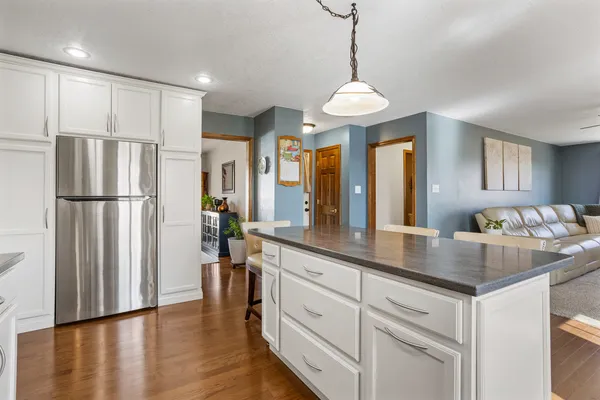 a kitchen with stainless steel appliances granite countertop a refrigerator a oven a sink and white appliances