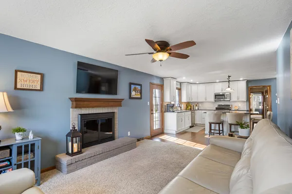 a living room with furniture a fireplace and a flat screen tv