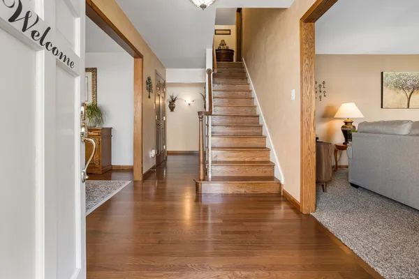a view of a hallway view with wooden floor and staircase