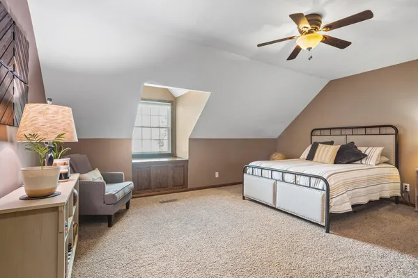 a bedroom with a bed and window