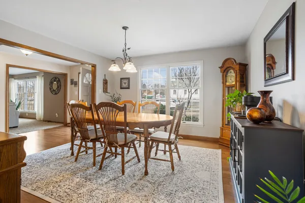 a view of a dining room with furniture and chandelier