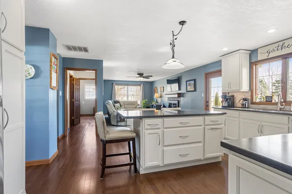 a kitchen with sink cabinets and wooden floor