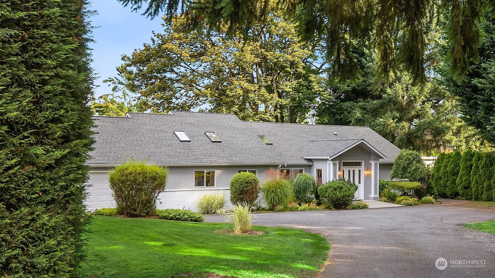 11302 East Riverside Drive Bothell, WA 98011 - Photo 1 of 37 a front view of a house with a yard and a porch