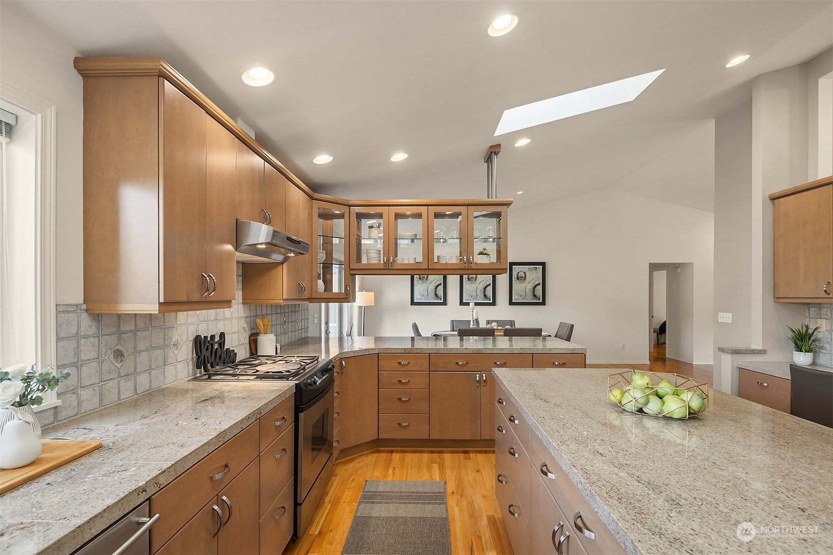 11302 East Riverside Drive Bothell, WA 98011 - Photo 15 of 37 a large kitchen with a large counter top a sink stainless steel appliances and cabinets