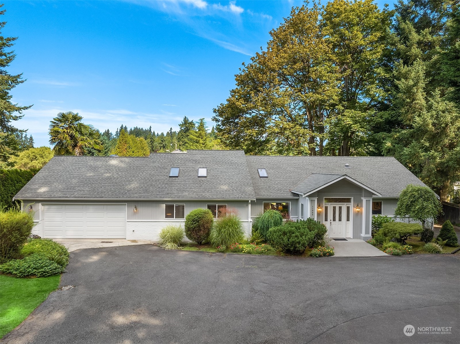 11302 East Riverside Drive Bothell, WA 98011 - Photo 2 of 37 a view of house with a yard and a large tree