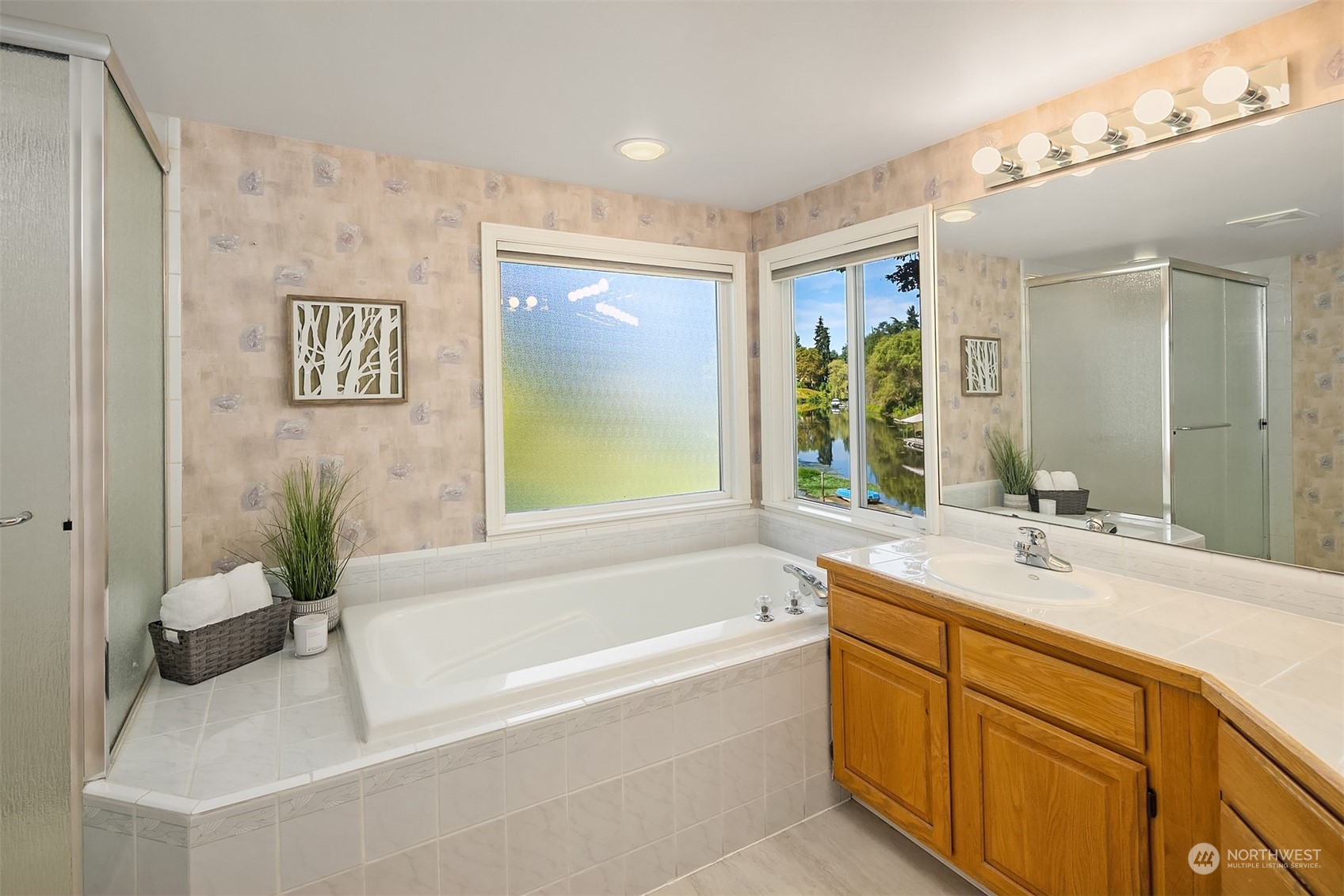 11302 East Riverside Drive Bothell, WA 98011 - Photo 28 of 37 a bathroom with a tub sink and mirror