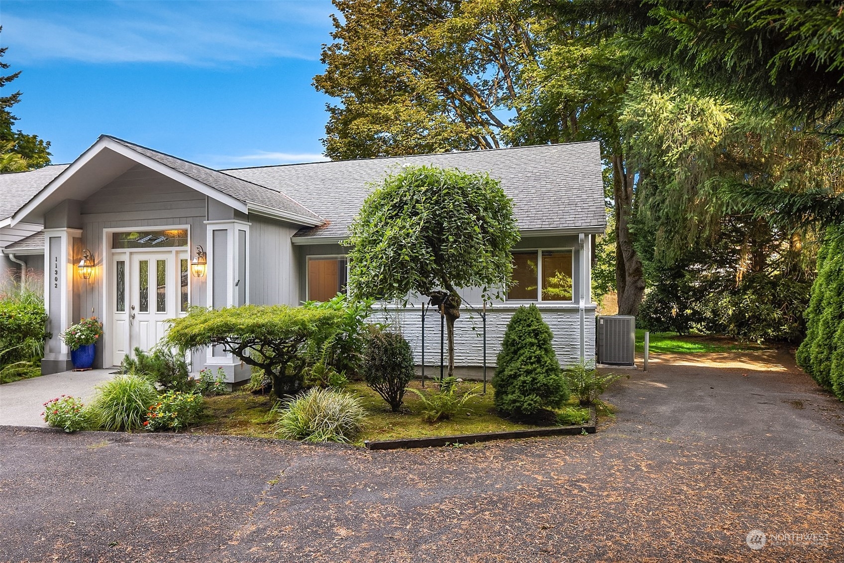 11302 East Riverside Drive Bothell, WA 98011 - Photo 36 of 37 a front view of a house with a yard and potted plants