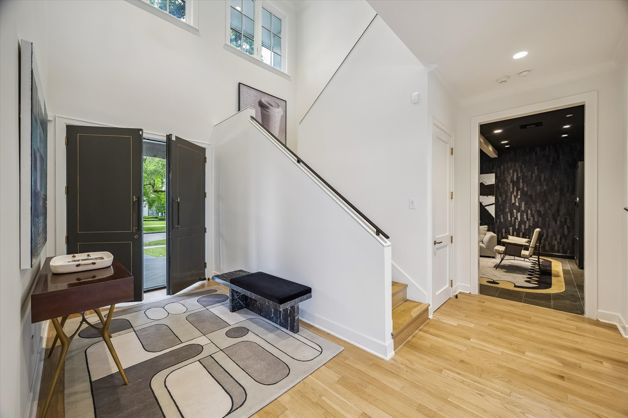 3706 Tangley Street Houston, TX 77005 - Photo 25 of 50 A sculptural staircase anchors the foyer, adding architectural interest and a sense of movement. The vertical volume enhances the home’s airy feel while drawing your eye upward. It’s a striking focal point that balances form and function beautifully.