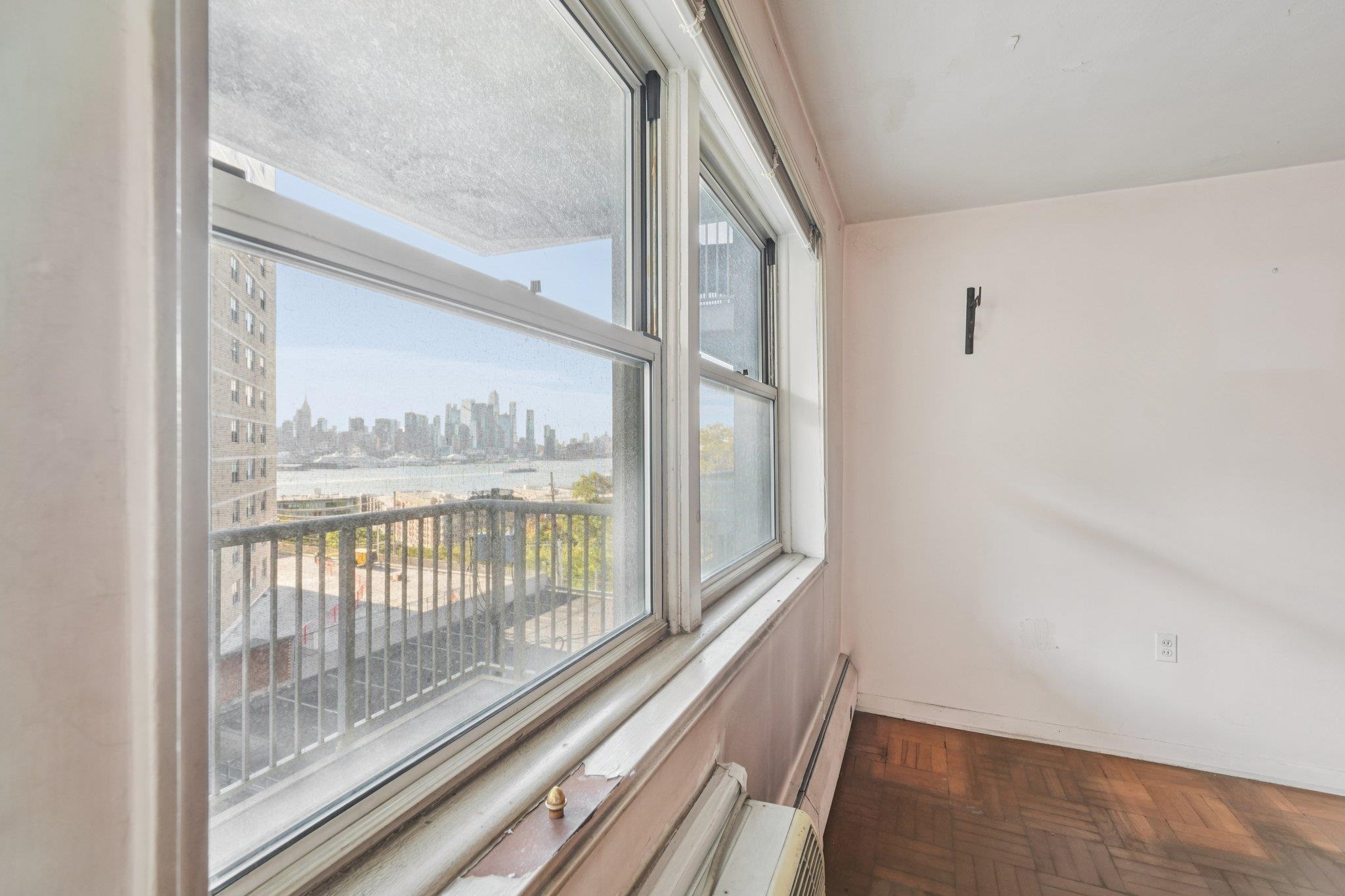 6010 Boulevard East, Unit 54 West New York, NJ 07093 - Photo 6 of 20 a view of a room with wooden floor and windows