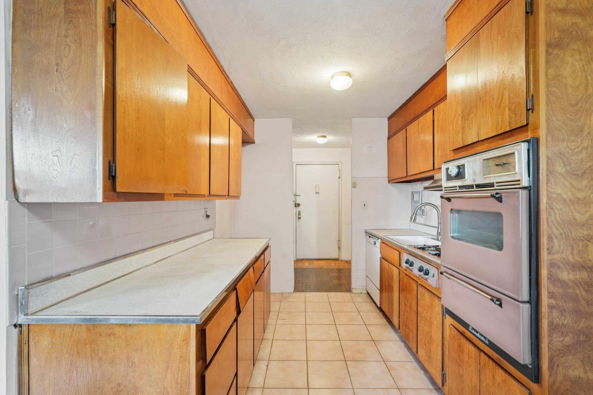 6010 Boulevard East, Unit 54 West New York, NJ 07093 - Photo 8 of 20 a kitchen with stainless steel appliances granite countertop a sink and cabinets