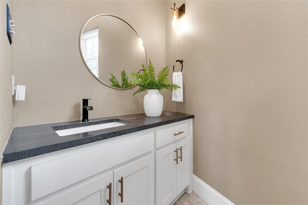 5102 Ridgedale Avenue Dallas, TX 75206 - Photo 12 of 27 Vanity featuring a dark countertop, integrated rectangular sink, and matte black faucet