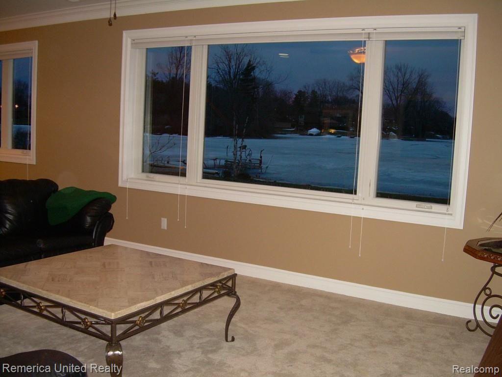 3467 East Commerce Road Commerce Township, MI 48382 - Photo 28 of 36 Large windows in lower level walkout offering lots of natural light and beautiful lake views.