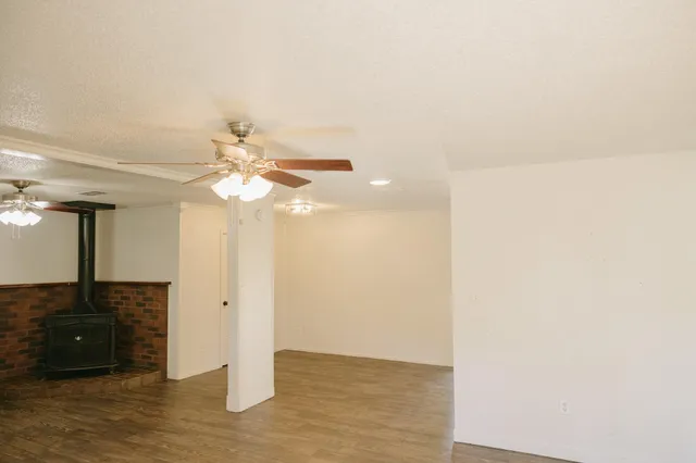 a view of a living room with hardwood floor and a ceiling fan