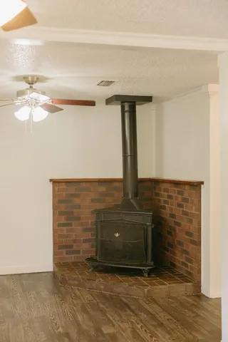 an empty room with a mirror and a wooden floor