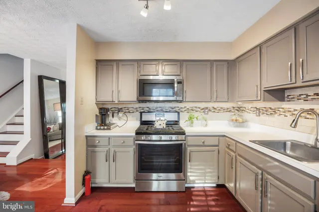 a kitchen with a stove top oven and cabinets