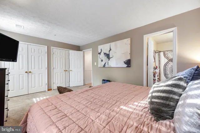 a bedroom with a large bed and a flat screen tv