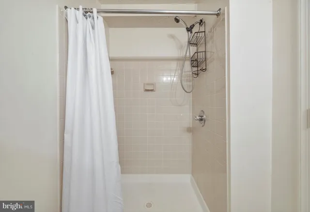 a bathroom with a glass shower door