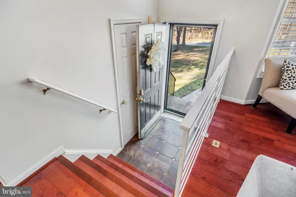 a view of a hallway view with wooden floor and windows