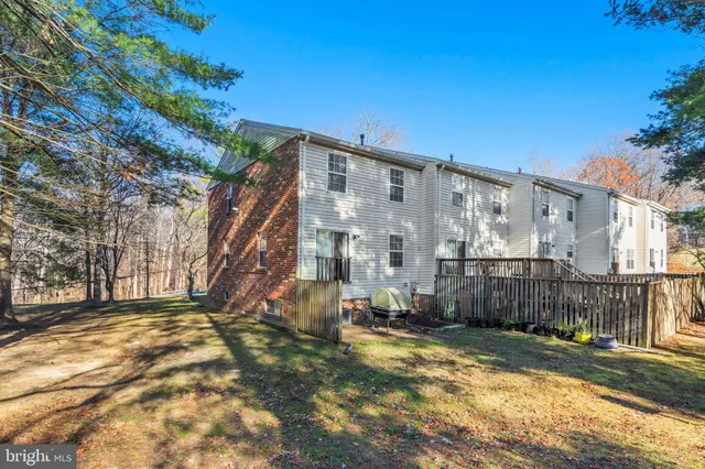 a view of a yard with wooden fence