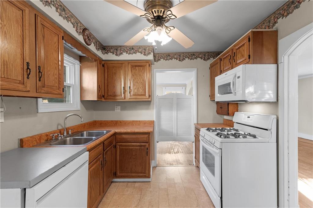4004 Kleber Street Pittsburgh, PA 15212 - Photo 11 of 35 a kitchen with stainless steel appliances granite countertop a sink and cabinets