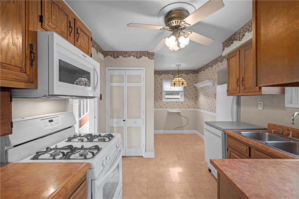 4004 Kleber Street Pittsburgh, PA 15212 - Photo 12 of 35 a kitchen with stainless steel appliances granite countertop a stove a sink and a refrigerator