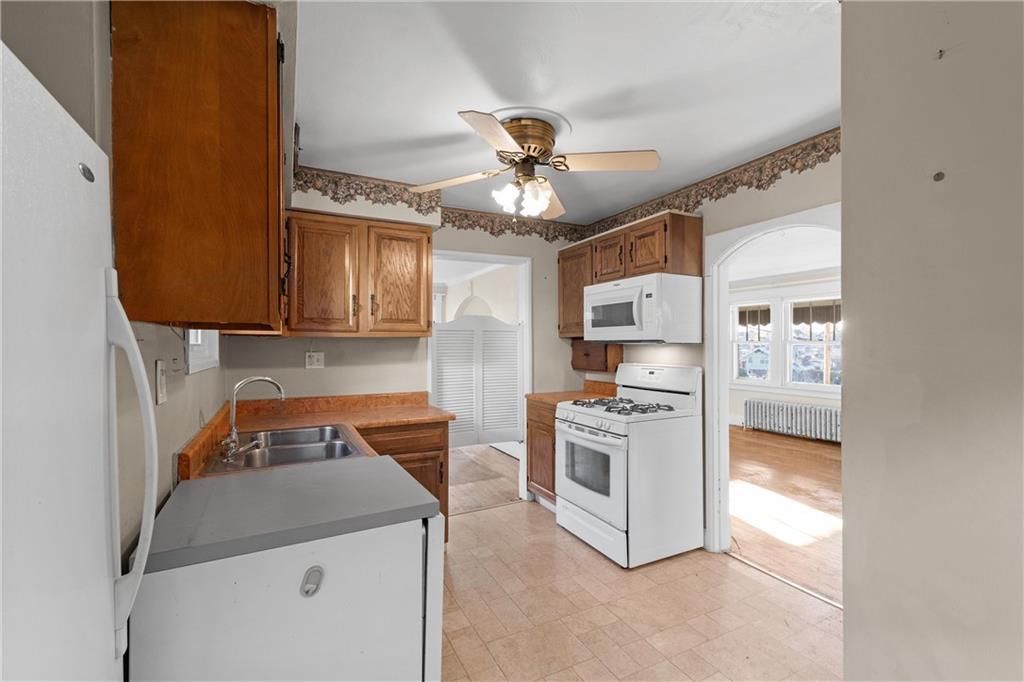 4004 Kleber Street Pittsburgh, PA 15212 - Photo 14 of 35 a kitchen with stainless steel appliances granite countertop a stove sink and refrigerator
