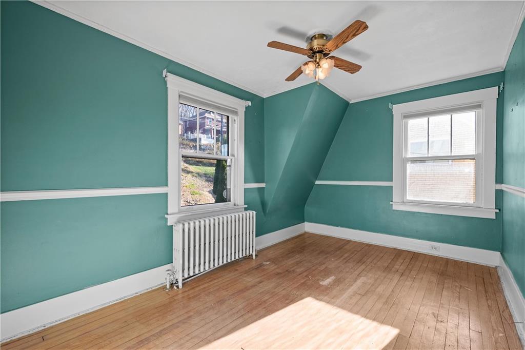 4004 Kleber Street Pittsburgh, PA 15212 - Photo 19 of 35 an empty room with wooden floor fan and a window