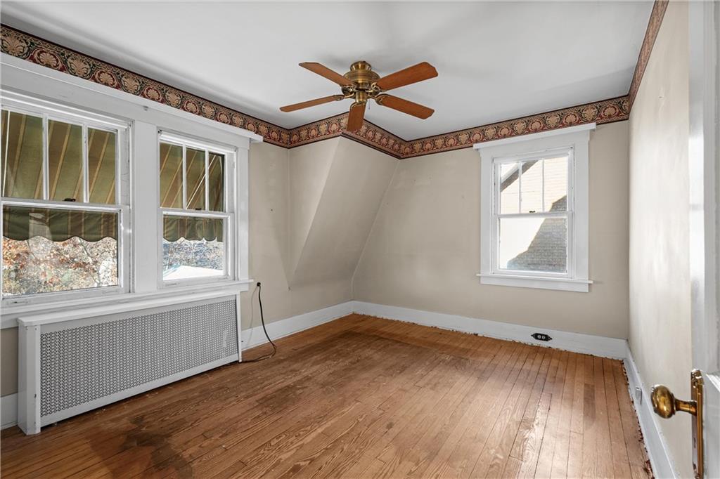 4004 Kleber Street Pittsburgh, PA 15212 - Photo 21 of 35 a view of an empty room with wooden floor and a window