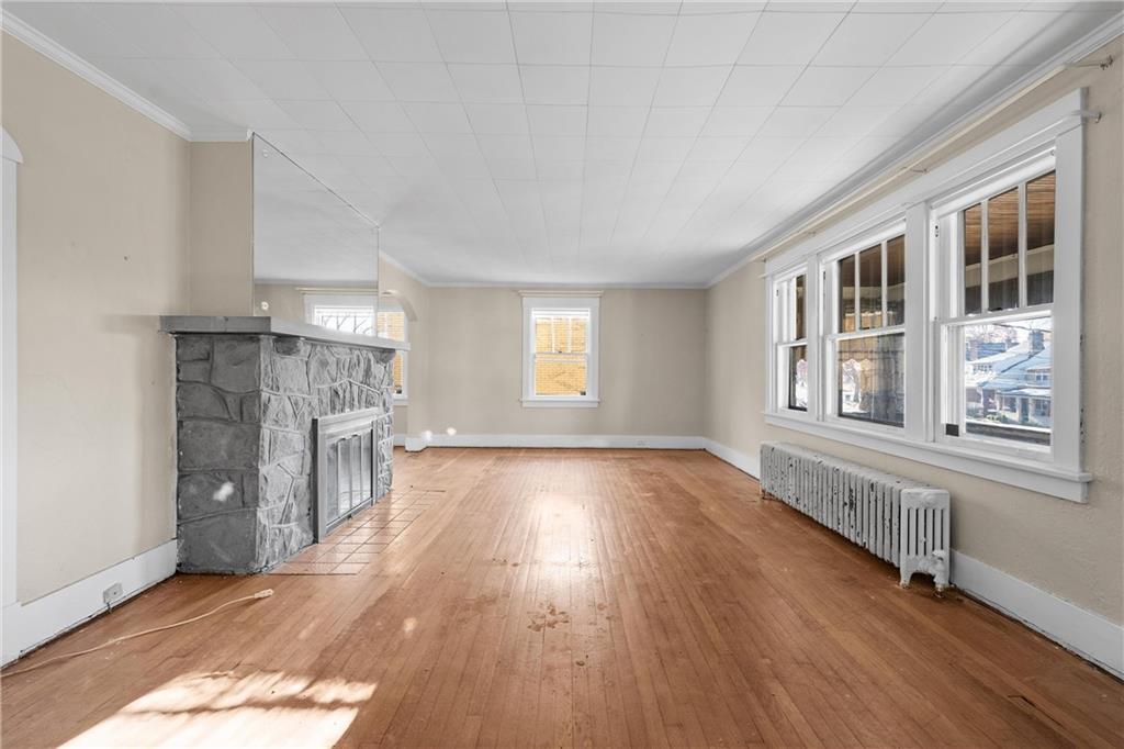 4004 Kleber Street Pittsburgh, PA 15212 - Photo 5 of 35 a view of an empty room with a window and wooden floor