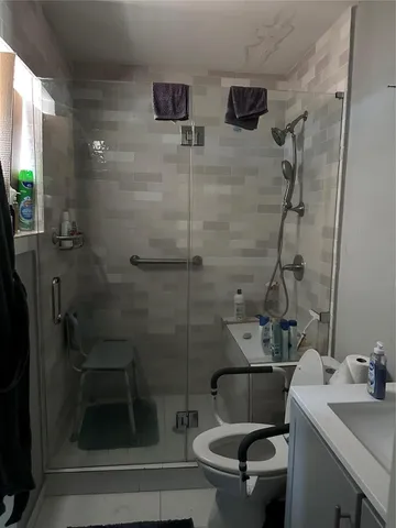 a bathroom with a sink toilet and shower