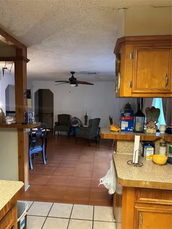 a kitchen with a sink a stove and chairs