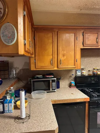 a kitchen with a sink a stove and a microwave