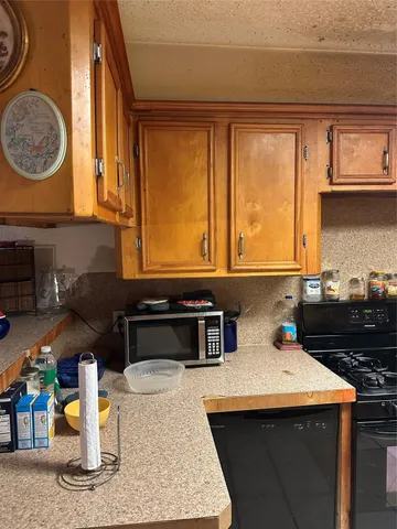 a kitchen with a sink a stove and a microwave