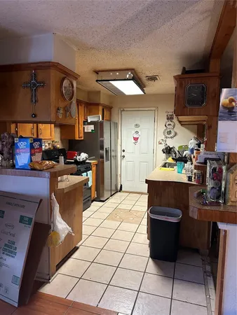 a kitchen with stainless steel appliances kitchen island granite countertop a sink and cabinets