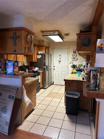 a kitchen with stainless steel appliances kitchen island granite countertop a sink and cabinets