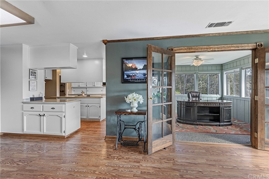 45943 Black Oak Road Coarsegold, CA 93614 - Photo 20 of 64 a kitchen with granite countertop a refrigerator cabinets and wooden floor