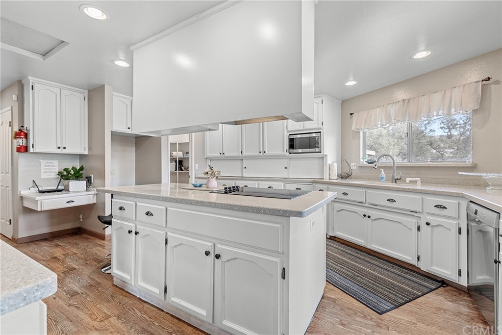 45943 Black Oak Road Coarsegold, CA 93614 - Photo 23 of 64 a kitchen with white cabinets and white appliances