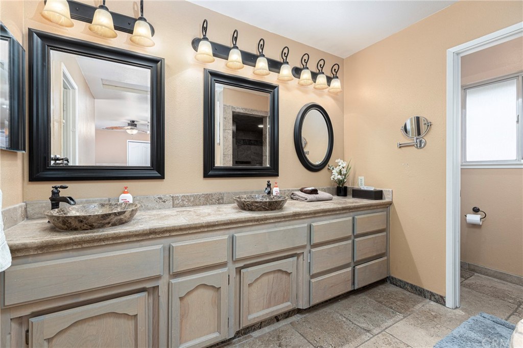 45943 Black Oak Road Coarsegold, CA 93614 - Photo 32 of 64 a bathroom with a double vanity sink and a mirror